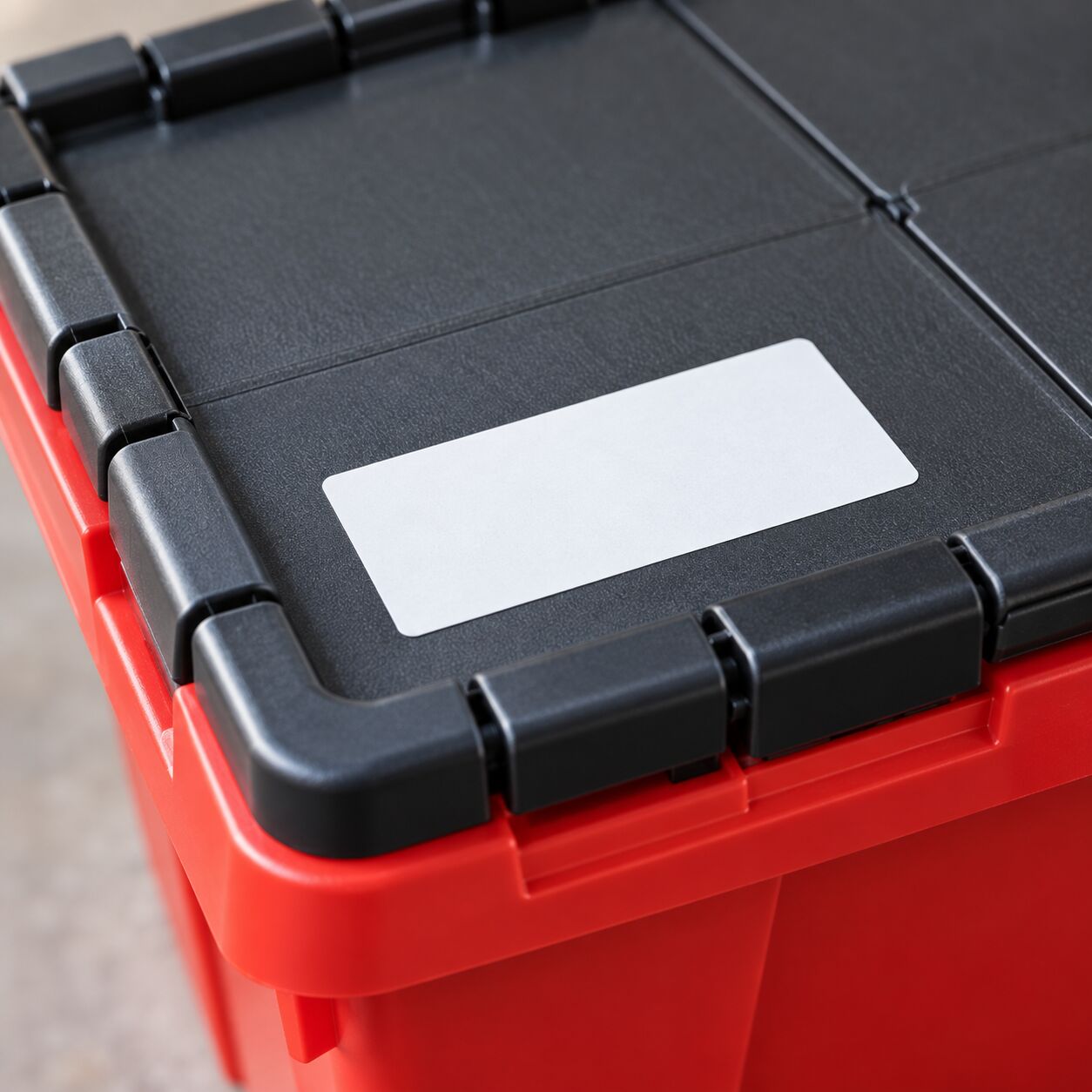 Close-up of a white label on a red tote lid